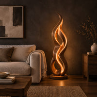 Floor lamp shaped like a twisting flame on a flat disc base in a dark living room at golden hour