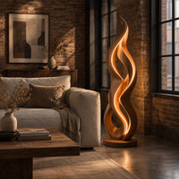 Floor lamp shaped like a twisting flame on a flat disc base in an industrial loft living room with exposed brick