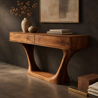 Corner detail of console table with two flat front panels, flared legs and an oval base beside wood, brass and linen samples