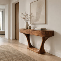 Console table with two flat front panels, flared legs and an oval base in a Scandinavian entryway with white walls