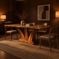 Rectangular dining table with two flared pedestal legs on a stepped plinth in an evening dining room with walnut wall paneling