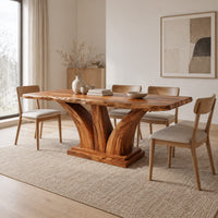 Rectangular dining table with two flared pedestal legs on a stepped plinth in a Scandinavian dining room with white walls
