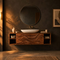 Floating bathroom vanity with carved wave doors and open end shelves in a dark bathroom at golden hour