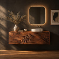 Floating bathroom vanity with wave carved drawer fronts in a dark studio against a charcoal plaster wall