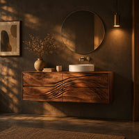 Floating bathroom vanity with wave carved drawer fronts in a dark bathroom at golden hour