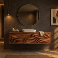 Floating bathroom vanity with three carved wave fronts in a dark bathroom at golden hour