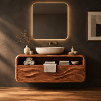 Floating vanity cabinet with carved wave fronts and an open top niche in a dark studio against a charcoal plaster wall