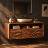 Floating vanity cabinet with carved wave fronts and an open top niche, three-quarter view showing the grain