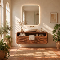Floating vanity cabinet with carved wave fronts and an open top niche in a bright bathroom with arched windows and plants