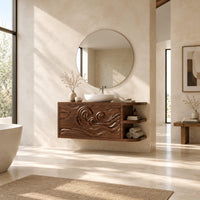 Floating cabinet with carved swirling wave front and open side shelves in a bright open plan bathroom