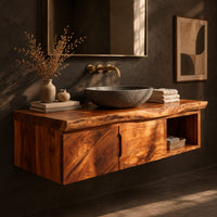 Corner detail of floating wooden vanity cabinet with a live edge top and open side niche beside wood, brass and linen samples