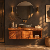 Floating wooden vanity cabinet with a live edge top and open side niche in a dark bathroom at golden hour