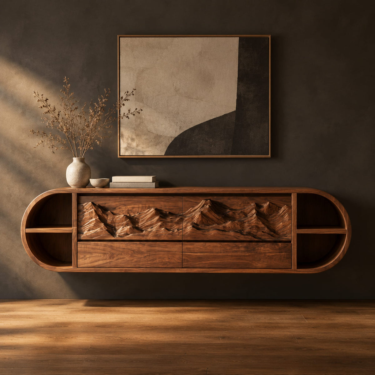 Pill shaped floating cabinet with carved mountain front and open end cubbies in a dark studio against a charcoal plaster wall