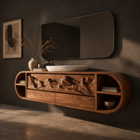 Pill shaped floating cabinet with carved mountain front and open end cubbies, three-quarter view showing the grain