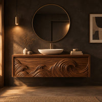 Floating cabinet with ocean wave relief carved across three fronts in a dark bathroom at golden hour