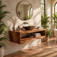 Floating wooden bathroom vanity with a slab top and an open shelf below in a bright bathroom with arched windows and plants