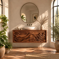 Floating bathroom vanity with two doors carved in ocean waves in a bright bathroom with arched windows and plants