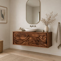 Floating bathroom vanity with two doors carved in ocean waves in a Scandinavian bathroom with white walls