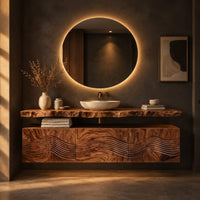 Floating wood cabinet with wave carved fronts and a live edge slab top in a dark bathroom at golden hour