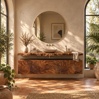 Floating wood cabinet with wave carved fronts and a live edge slab top in a bright bathroom with arched windows and plants