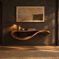 Floating console table with a sweeping wave shaped underside in a dark entryway at golden hour
