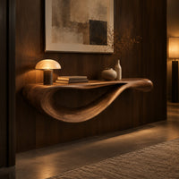 Floating console table with a sweeping wave shaped underside in an evening entryway with walnut wall paneling