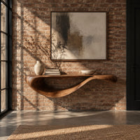 Floating console table with a sweeping wave shaped underside in an industrial loft entryway with exposed brick