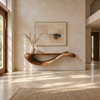 Floating console table with a sweeping wave shaped underside in a bright open plan entryway