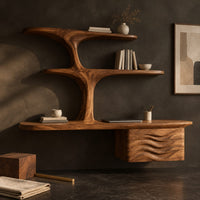 Corner detail of floating desk with tree form shelves and a wave carved side unit beside wood, brass and linen samples