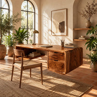 Floating desk with a soft edged body, open cubby shelf and two drawers in a bright home office with arched windows and plants