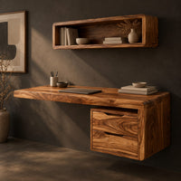 Corner detail of floating desk with a thick grained top and a hanging two drawer pedestal beside wood, brass and linen samples