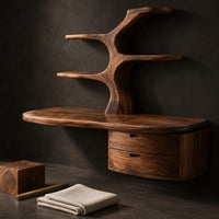 Corner detail of floating desk with a tree trunk, branch shelves and two drawers beside wood, brass and linen samples