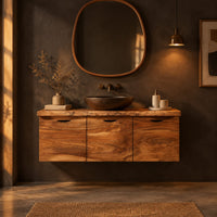 Floating wood cabinet with three doors and a live edge top in a dark bathroom at golden hour