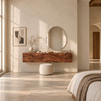 Floating makeup vanity with a carved wave front and a tall open shelf in a bright open plan bedroom