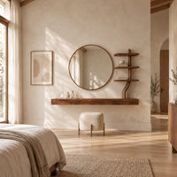 Floating wood makeup vanity with a circular mirror and a branch shaped tiered shelf in a bright open plan bedroom