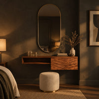 Floating makeup vanity with an open niche and a wave carved front panel in a dark bedroom at golden hour