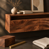 Corner detail of floating makeup vanity with an open top niche and two wave grain fronts beside wood, brass and linen samples