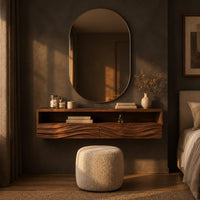Floating makeup vanity with an open top shelf and two wave carved fronts in a dark bedroom at golden hour