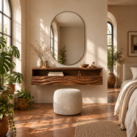 Floating makeup vanity with an open top shelf and two wave carved fronts in a bright bedroom with arched windows and plants