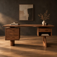 Desk with a floating top over two raised drawer cabinets in a dark studio against a charcoal plaster wall