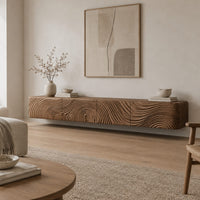 Floating tv stand with swirling tree ring carved fronts in a Scandinavian living room with white walls