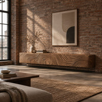 Floating tv stand with swirling tree ring carved fronts in an industrial loft living room with exposed brick