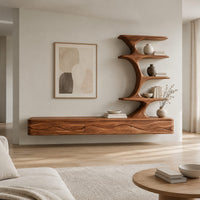 Floating media stand with wave carved fronts and a sculptural tiered shelf tower in a Scandinavian living room with white walls