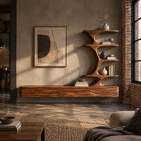 Floating media stand with wave carved fronts and a sculptural tiered shelf tower in an industrial loft living room with exposed brick