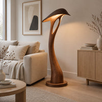Floor lamp with a bowed stem and a hooded leaf shade in a Scandinavian living room with white walls