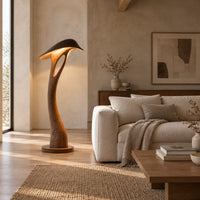 Floor lamp with a bowed stem and a hooded leaf shade in a bright open plan living room