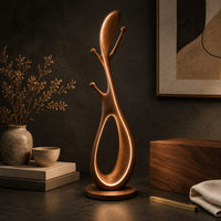 Corner detail of floor lamp with an open loop body, short pegs and a small side tray beside wood, brass and linen samples