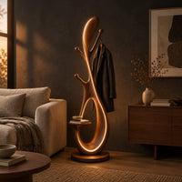 Floor lamp with an open loop body, short pegs and a small side tray in a dark living room at golden hour