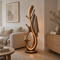Floor lamp with an open loop body, short pegs and a small side tray in a Scandinavian living room with white walls