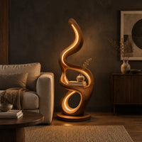 Floor lamp with serpentine loops and a small flat ledge in a dark living room at golden hour